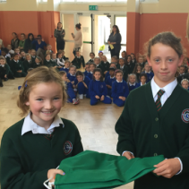 Aisling and Blátnid accepting the National Flag for Our School